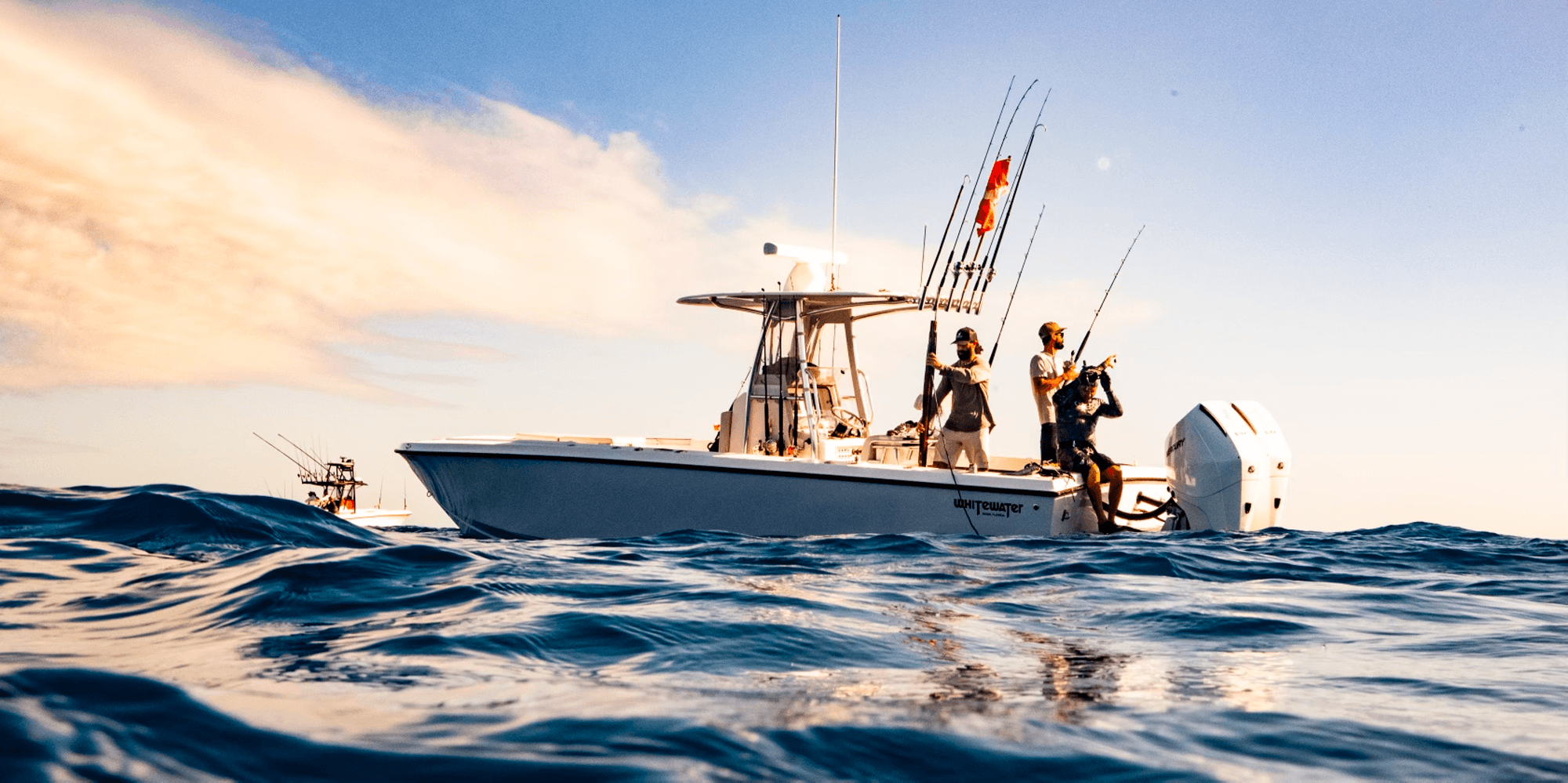 Charter fishing boat at water level during golden hour
