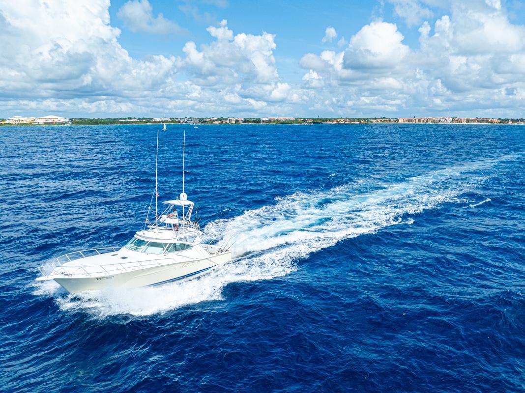 Aerial view of a charter fishing boat running across bluewater